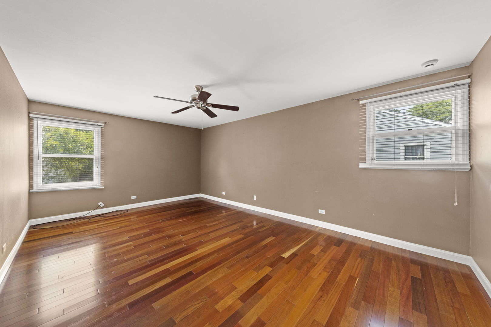 2114 Countryside Circle Naperville, IL 60565 - Photo 17 of 29 a view of an empty room with wooden floor and a window