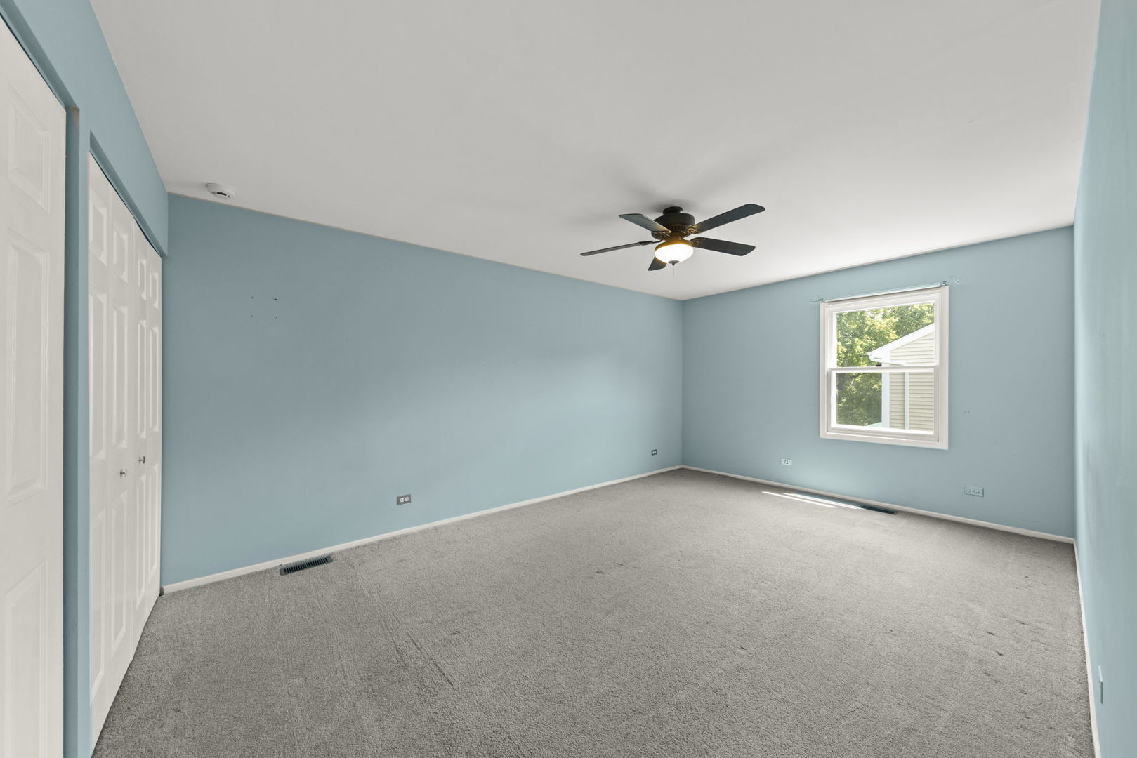 2114 Countryside Circle Naperville, IL 60565 - Photo 20 of 29 an empty room with a window and a ceiling fan