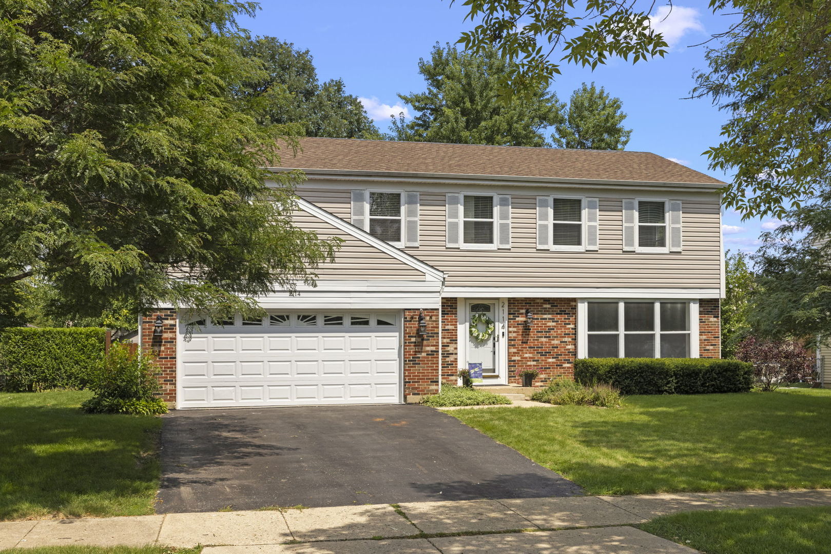 2114 Countryside Circle Naperville, IL 60565 - Photo 2 of 29 a front view of a house with a yard and garage