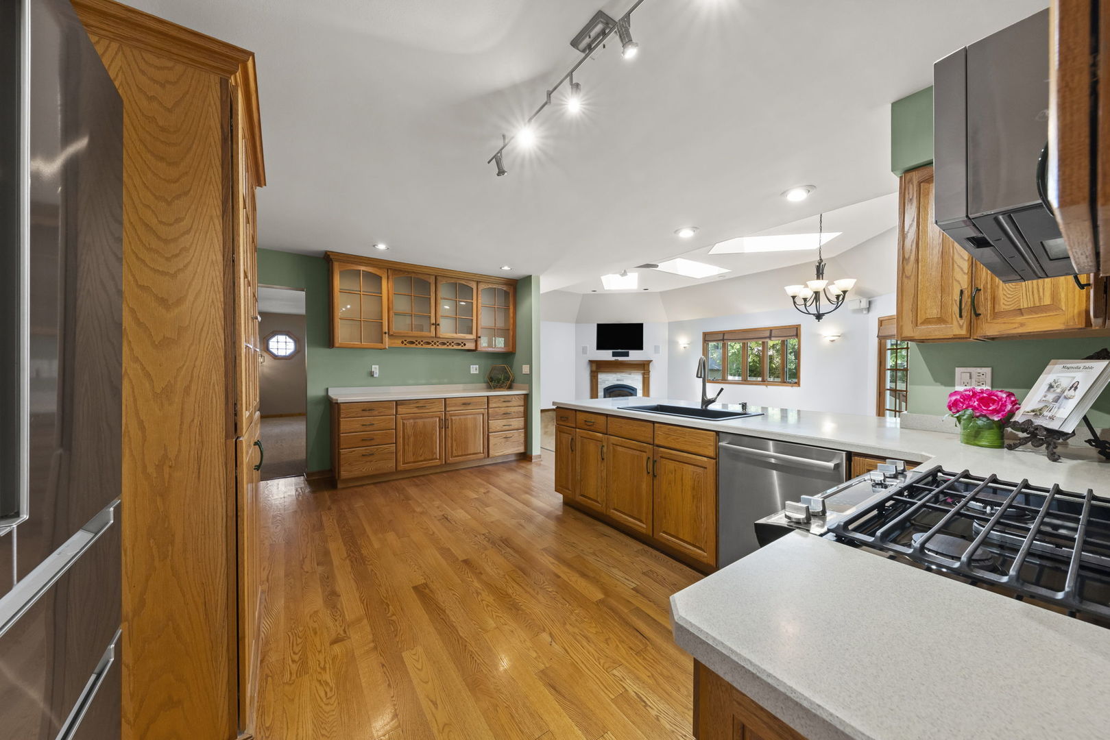 2114 Countryside Circle Naperville, IL 60565 - Photo 7 of 29 a kitchen with stainless steel appliances a sink a stove top oven a counter space and cabinets