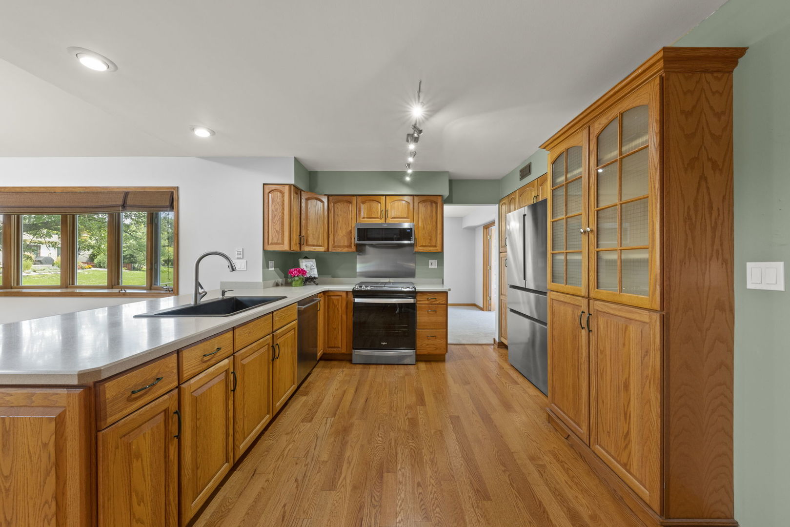 2114 Countryside Circle Naperville, IL 60565 - Photo 9 of 29 a large kitchen with stainless steel appliances a large counter top a stove and a wooden floors