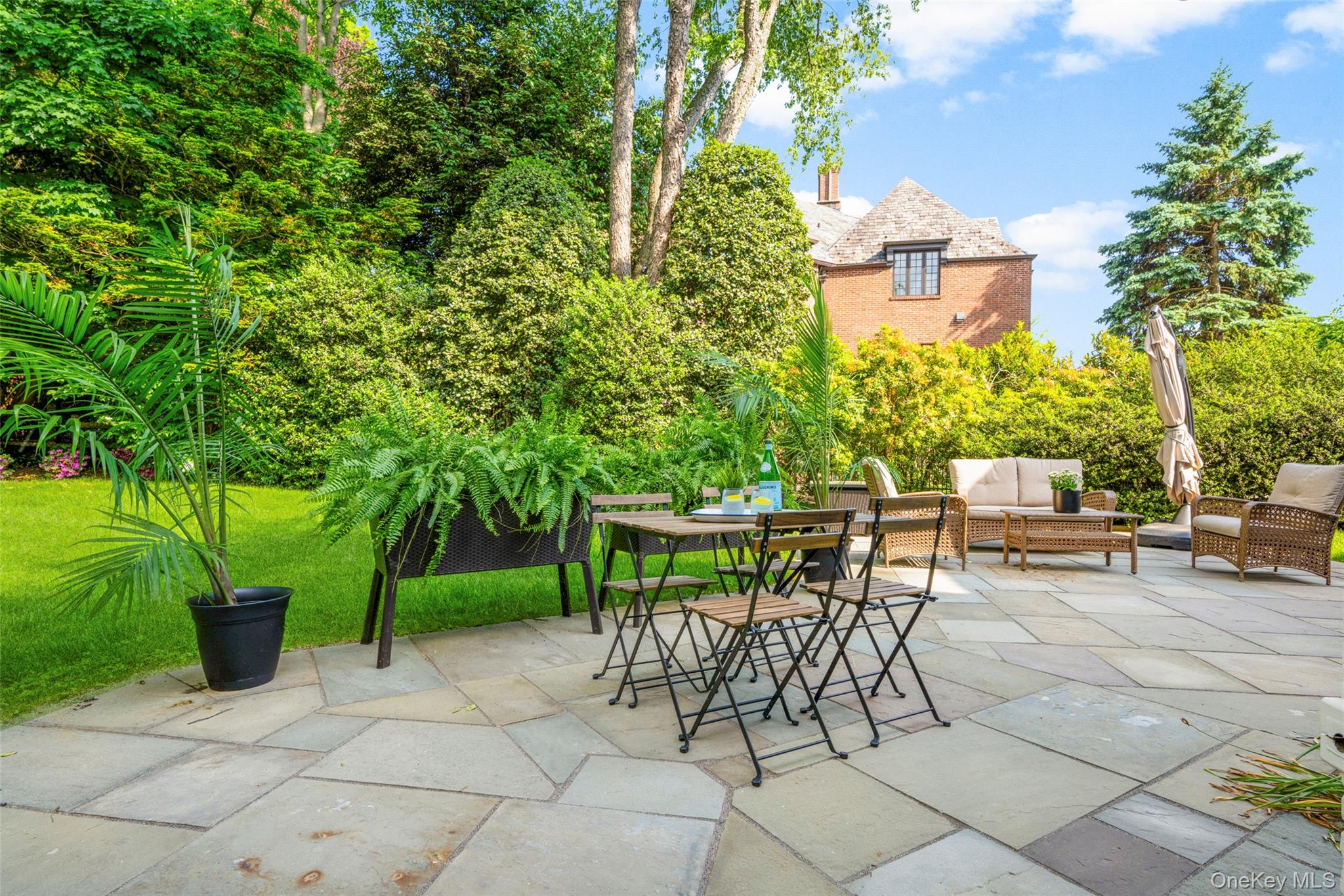 63 Rye Road Rye, NY 10580 - Photo 28 of 50 Tranquil outdoor entertaining space with bluestone patio and lush landscaped surroundings