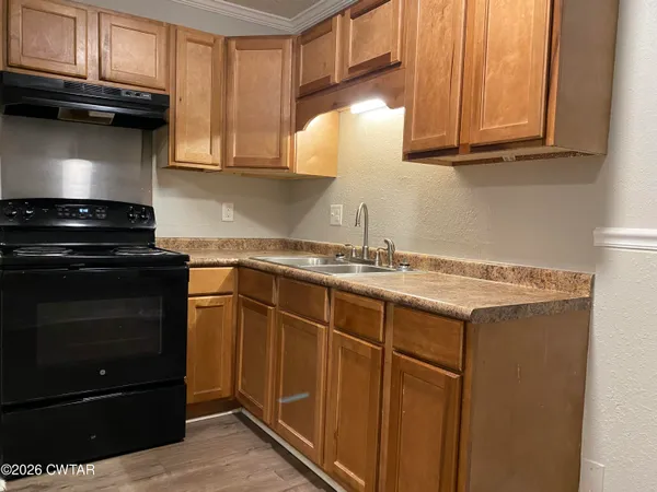 a kitchen with granite countertop cabinets and steel stainless steel appliances