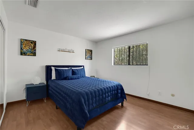 a bedroom with a bed and a night stand