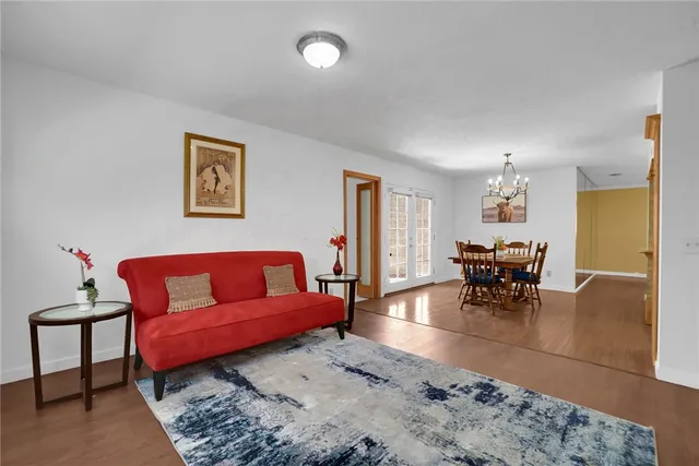 a living room with furniture and a dining table with kitchen view