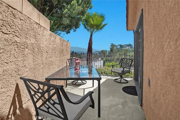 a balcony with table and chairs