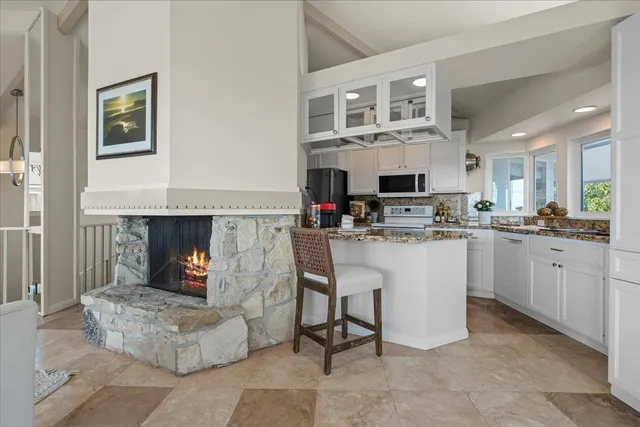 a kitchen with stainless steel appliances white cabinets and a refrigerator