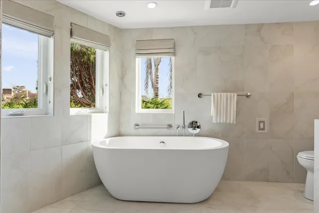 a view of walk in closet with clothes