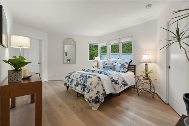 a patio with table and chairs and potted plants