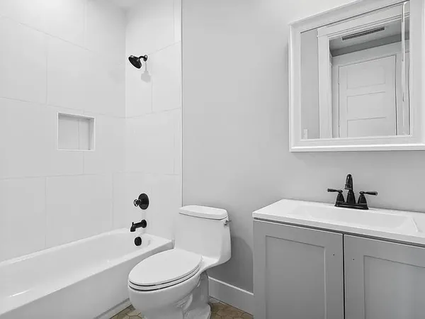a white toilet sitting next to a bathroom sink