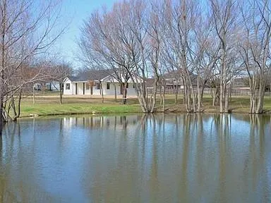 a view of a lake with a house in the background