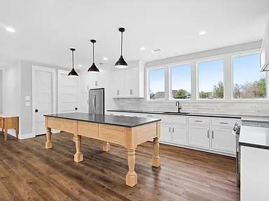 134 Crawford Road Argyle, TX 76226 - Photo 5 of 13 a kitchen with stainless steel appliances granite countertop a sink cabinets and wooden floor