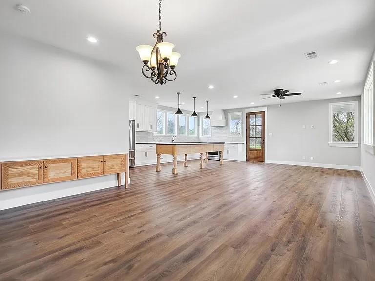 134 Crawford Road Argyle, TX 76226 - Photo 7 of 13 a view of a room with wooden floor fireplace and windows