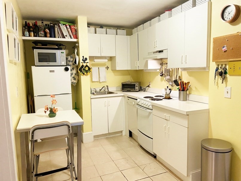 a kitchen with a sink cabinets and appliances