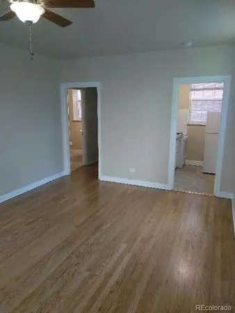 a view of wooden floor and windows in a room