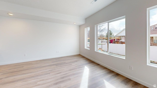 777 Pheasantbrook Drive, Unit 2B Centerville, UT 84014 - Photo 2 of 42 Open concept room featuring wood-finish flooring, recessed lighting, and multiple large windows with white trim