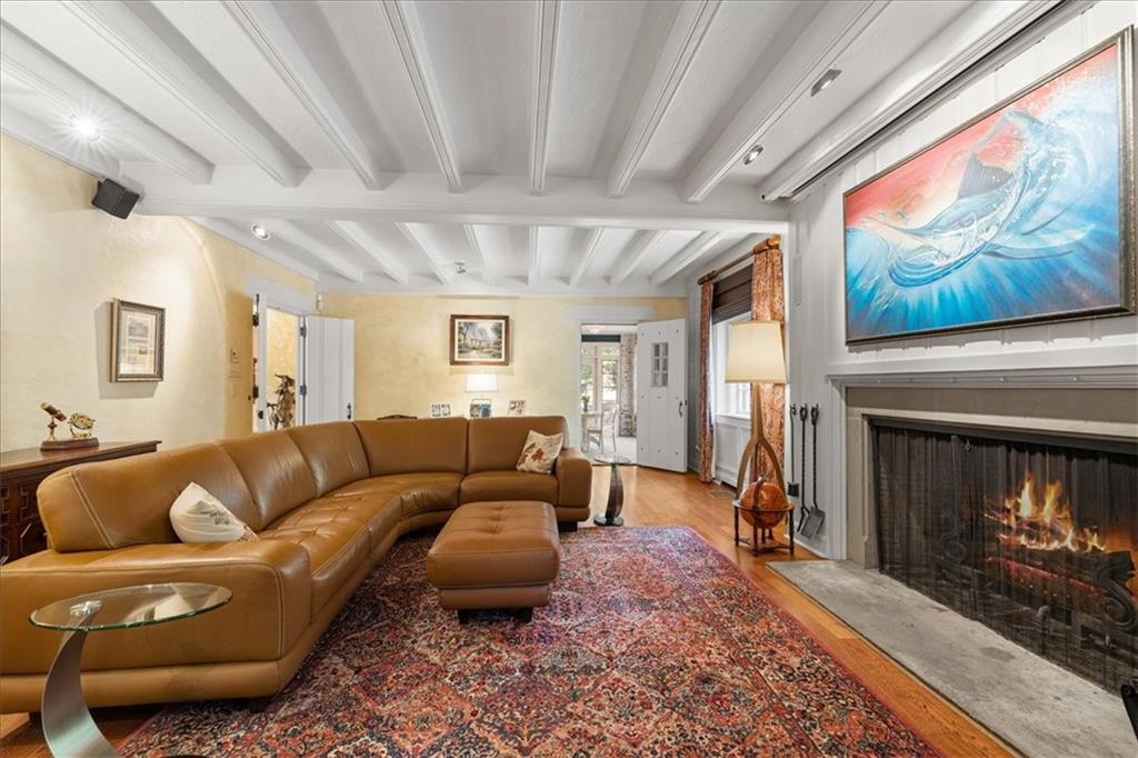 430 Woodland Road Sewickley, PA 15143 - Photo 11 of 49 a living room with furniture a fireplace and a painting on the wall