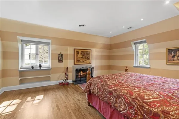a bedroom with a bed and a large window
