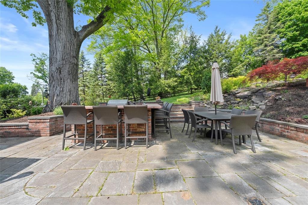 430 Woodland Road Sewickley, PA 15143 - Photo 42 of 49 a view of a tables and chairs on the patio