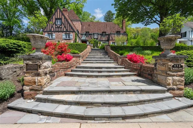 a view of a house with a yard and a garden