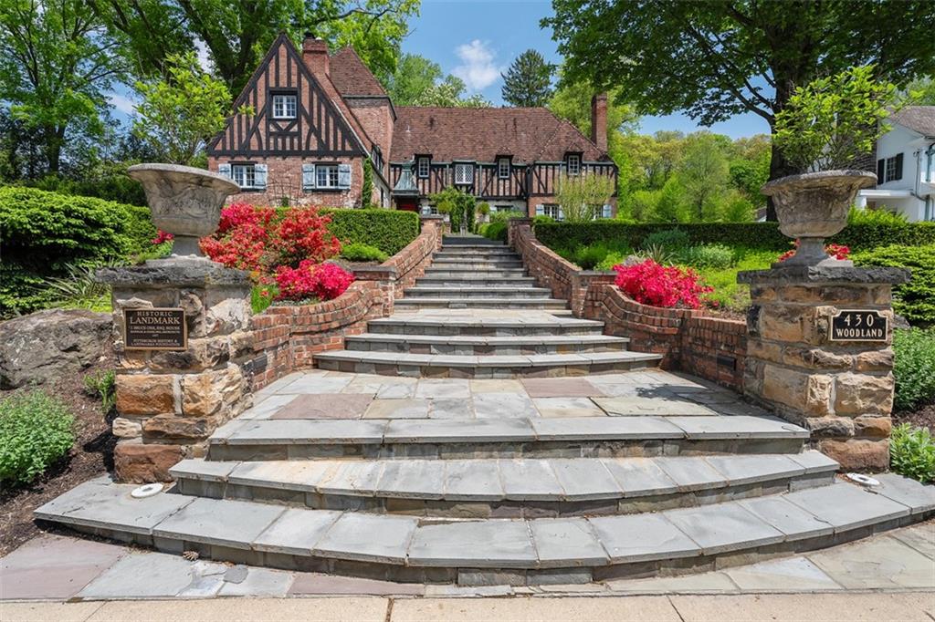 430 Woodland Road Sewickley, PA 15143 - Photo 5 of 49 a view of a house with a yard and a garden