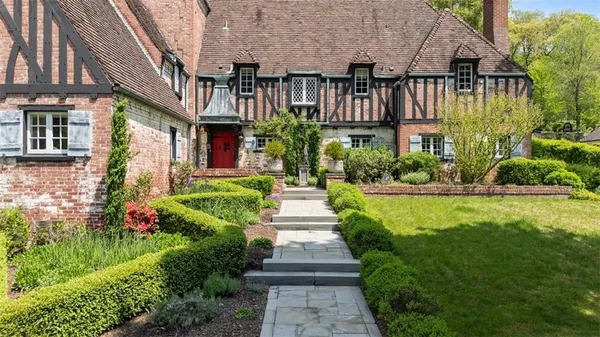 a front view of a house with garden