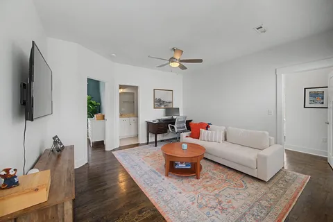 a bathroom with a toilet a sink and a large mirror