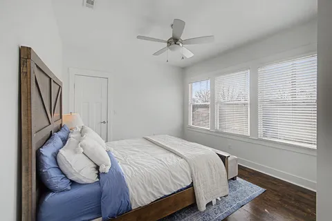 a bedroom with a bed and a ceiling fan