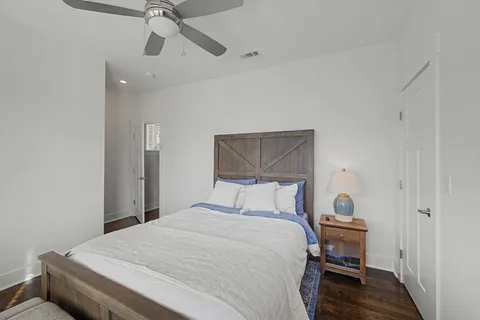 a bedroom with a large bed and a chandelier