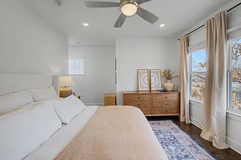 a spacious bathroom with a granite countertop sink and a mirror