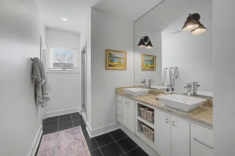 a bathroom with a shower and a sink