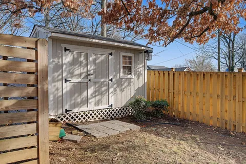 a view of a house with backyard porch and sitting area