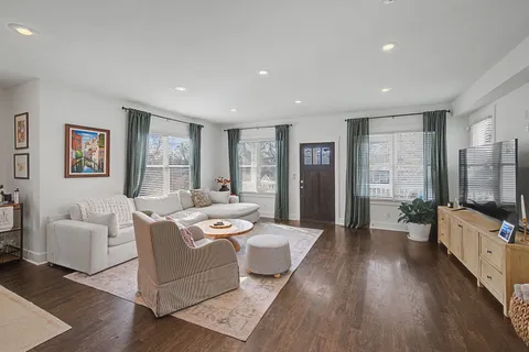 a living room with furniture wooden floor and a flat screen tv