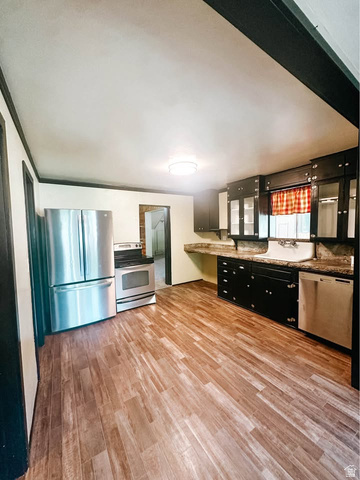 393 Old Mill Road Glenwood, UT 84730 - Photo 3 of 10 Kitchen featuring wood-finish flooring, stainless steel appliances, dark cabinetry, and stone-look countertops