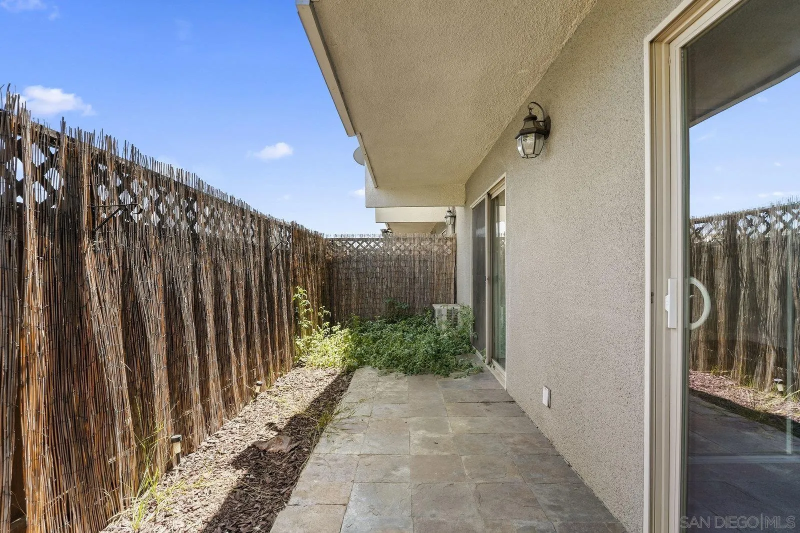 1045 Peach Avenue, Unit 59 El Cajon, CA 92021 - Photo 12 of 19 a view of a pathway of a building with wooden fence