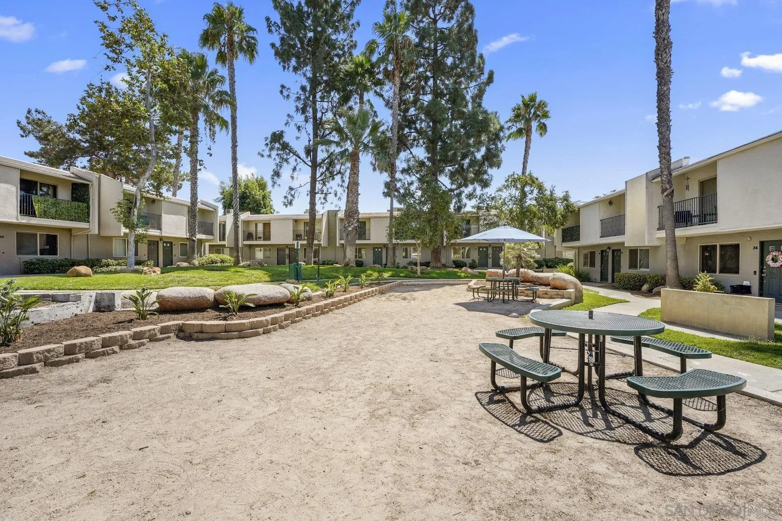 1045 Peach Avenue, Unit 59 El Cajon, CA 92021 - Photo 18 of 19 a view of a swimming pool with a lounge chairs