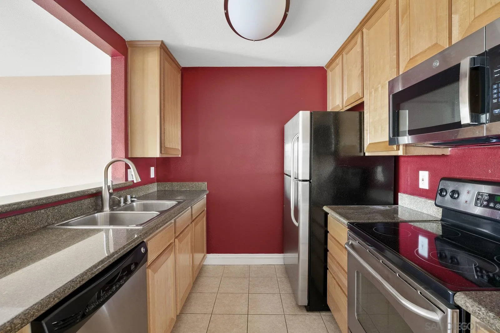 1045 Peach Avenue, Unit 59 El Cajon, CA 92021 - Photo 5 of 19 a kitchen with stainless steel appliances granite countertop a sink stove and refrigerator