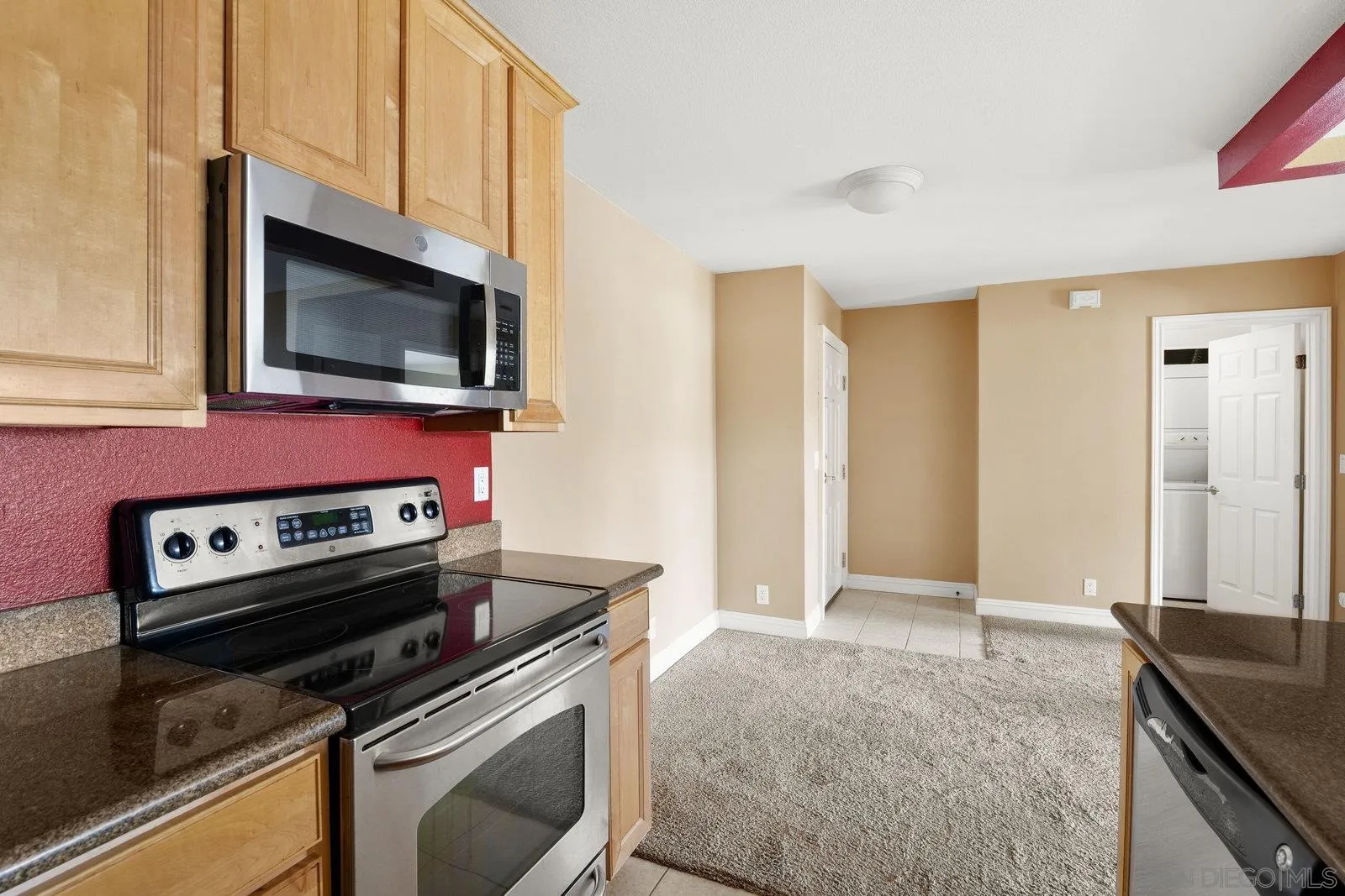 1045 Peach Avenue, Unit 59 El Cajon, CA 92021 - Photo 6 of 19 a kitchen with granite countertop a stove and a microwave