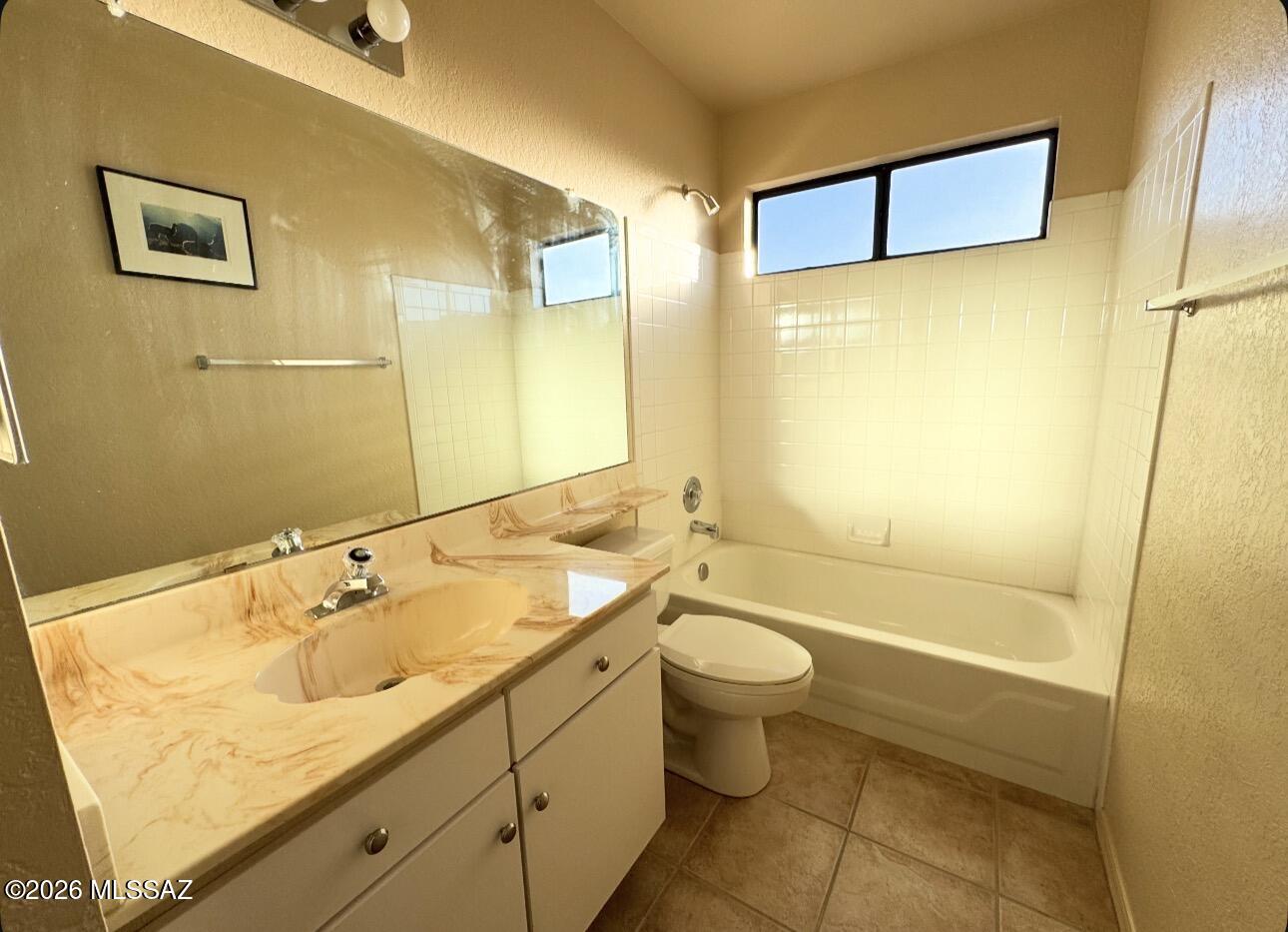 4998 North Valle Road Tucson, AZ 85750 - Photo 5 of 11 a bathroom with a granite countertop sink toilet and shower