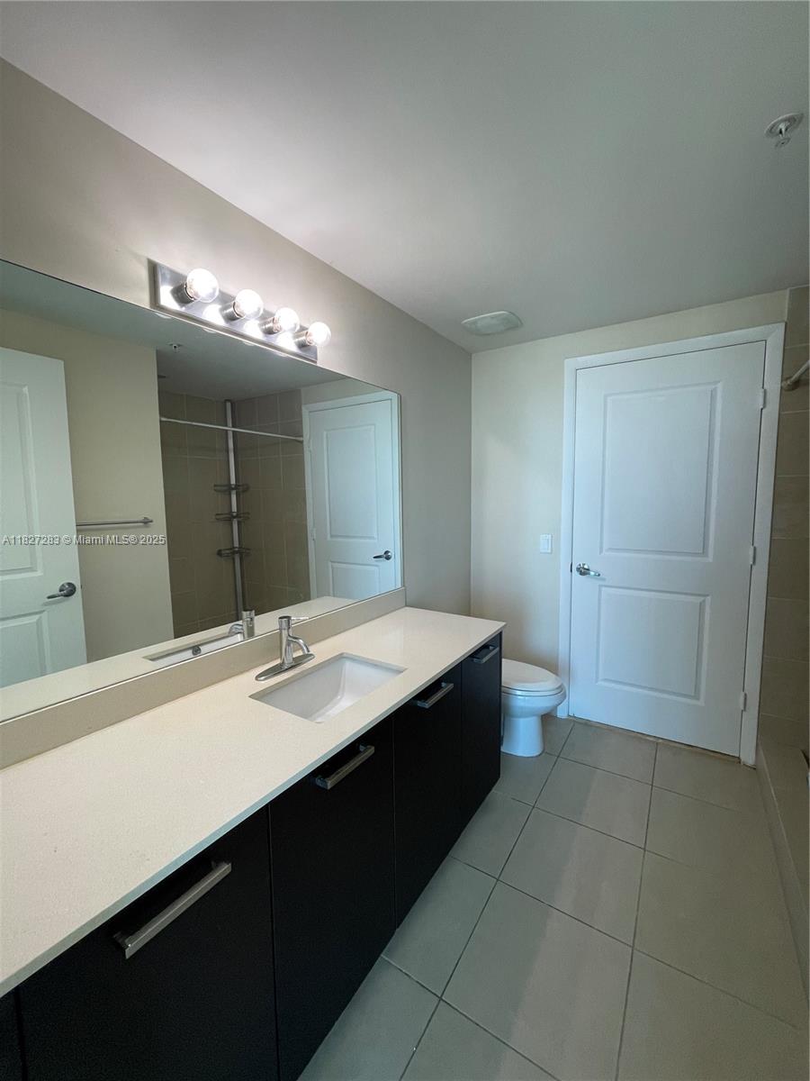 Edgewater Miami, FL 33137 - Photo 15 of 21 a bathroom with a sink a vanity and a mirror