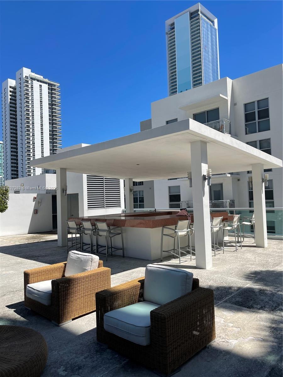 Edgewater Miami, FL 33137 - Photo 20 of 21 a outdoor living space with patio furniture and kitchen view