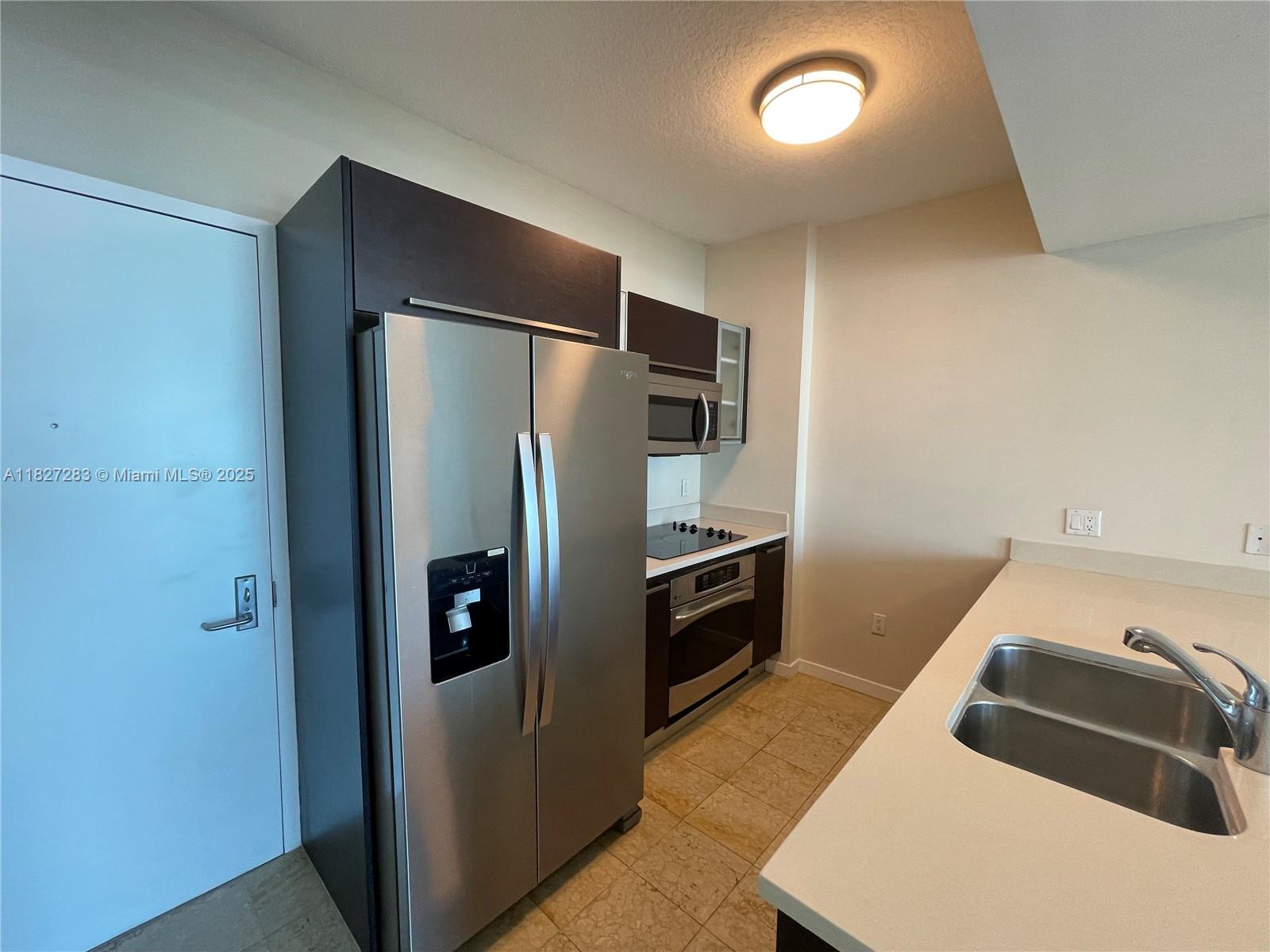 Edgewater Miami, FL 33137 - Photo 5 of 21 a kitchen with a refrigerator and a sink