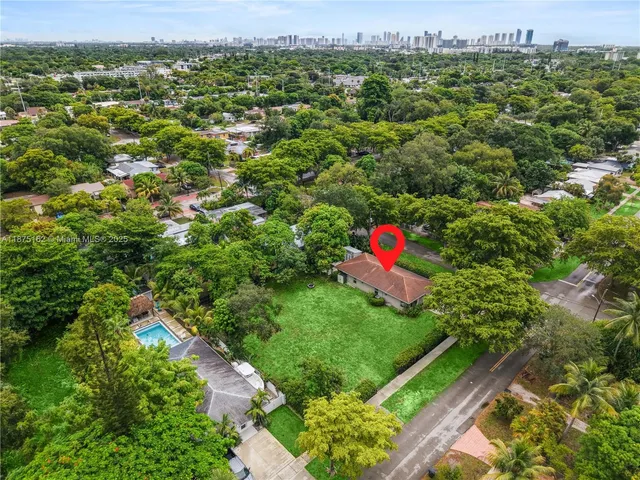 a view of a green field with lots of flower in it
