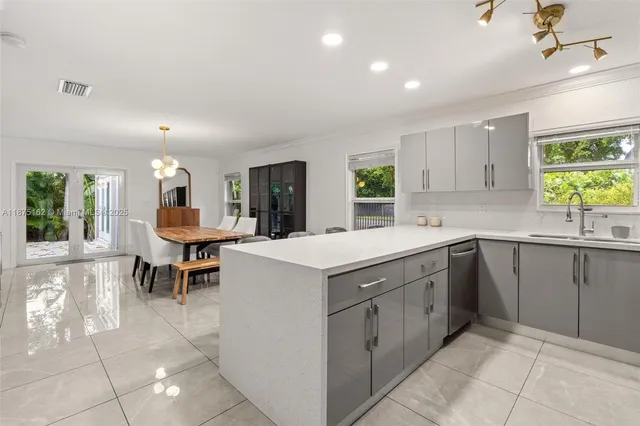 a kitchen with a sink a counter top space and appliances