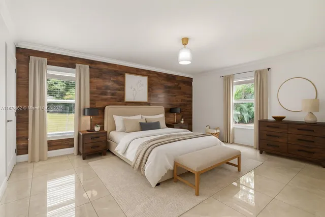 a bedroom with a bed mirror and window