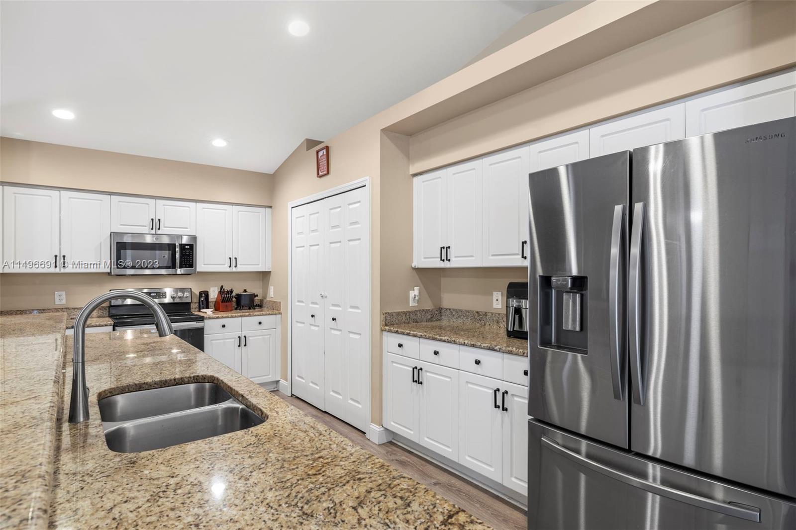 775 Arundel Circle Fort Myers, FL 33913 - Photo 11 of 26 a kitchen with stainless steel appliances granite countertop a refrigerator a stove and a sink