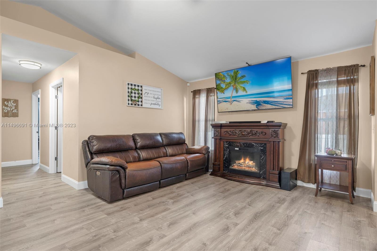 775 Arundel Circle Fort Myers, FL 33913 - Photo 16 of 26 a living room with furniture and a fireplace