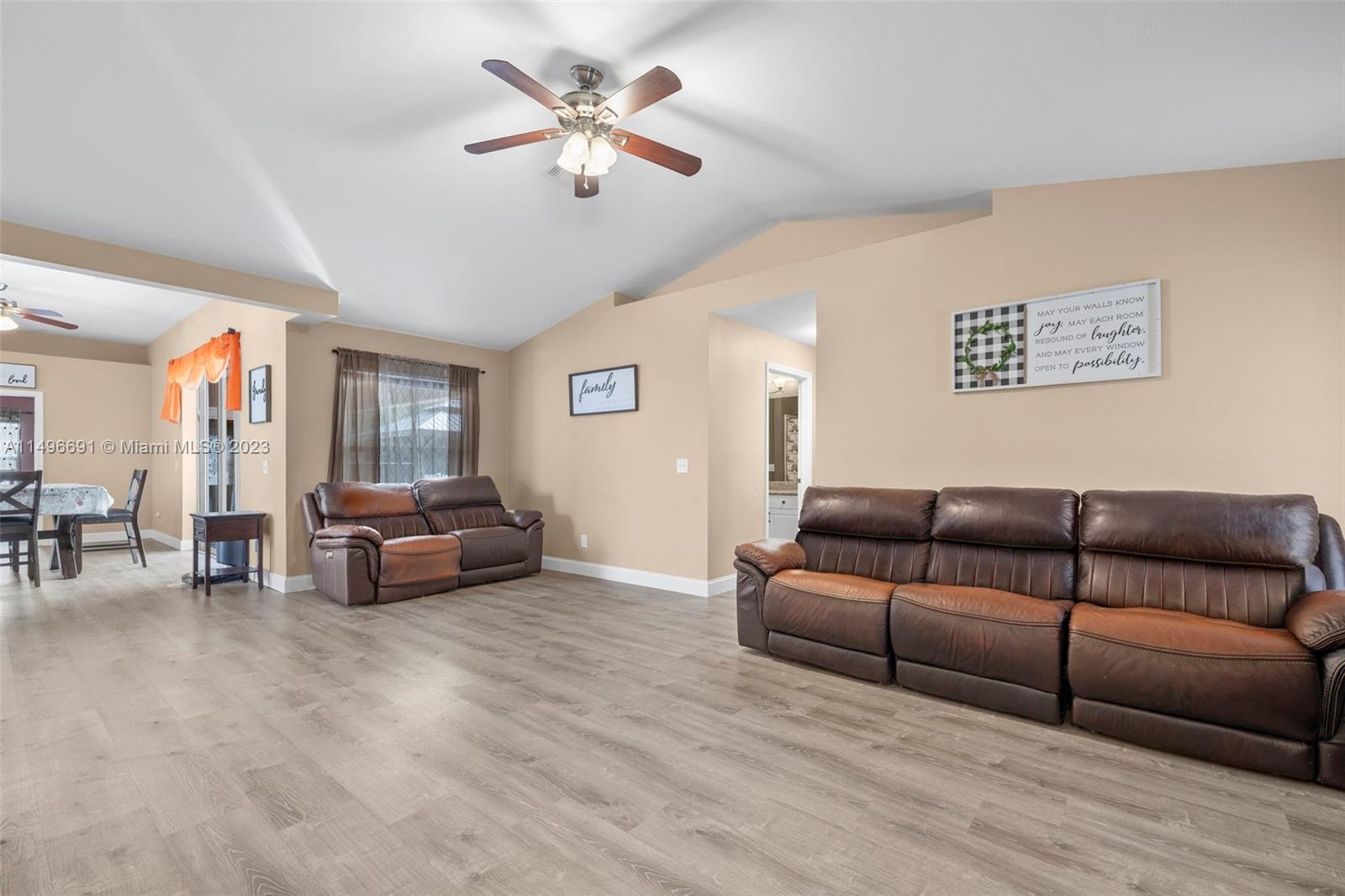 775 Arundel Circle Fort Myers, FL 33913 - Photo 17 of 26 a living room with furniture and a chandelier