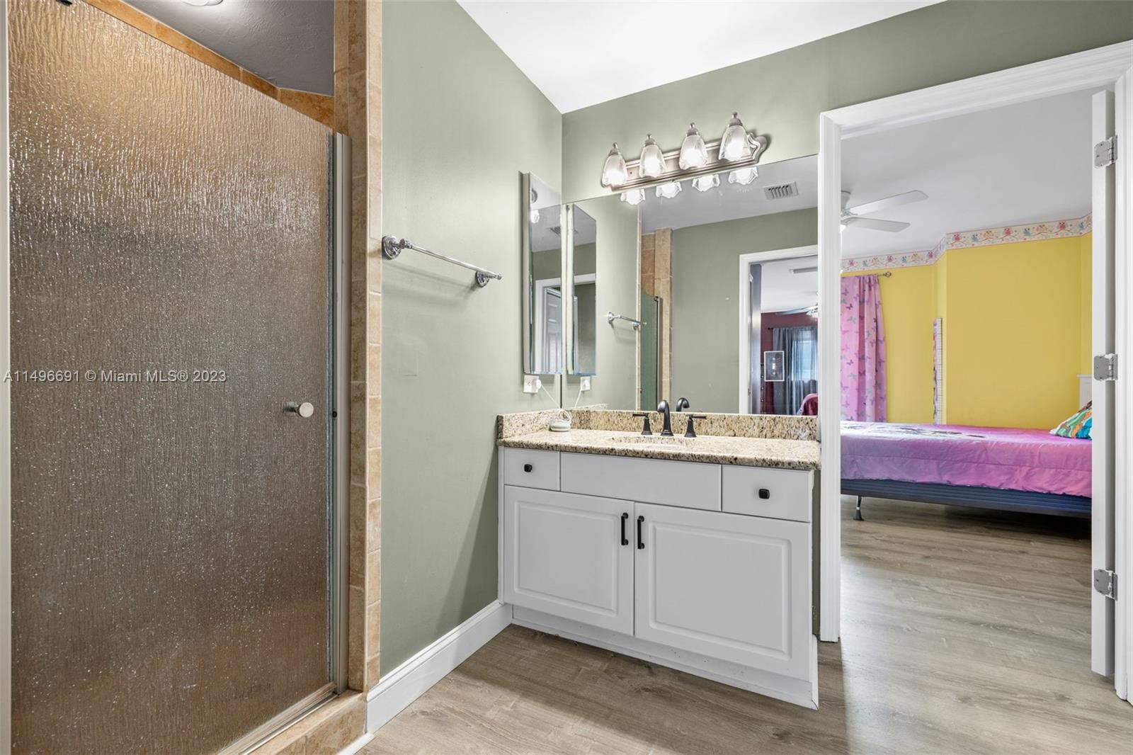 775 Arundel Circle Fort Myers, FL 33913 - Photo 18 of 26 a bathroom with a double vanity sink and a mirror