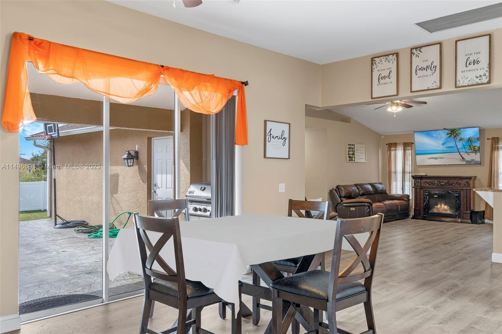 775 Arundel Circle Fort Myers, FL 33913 - Photo 6 of 26 a view of a dining room with furniture a fireplace and wooden floor
